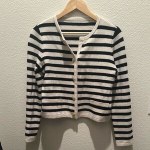 Elegant striped sweater with gold buttons. Classic design.